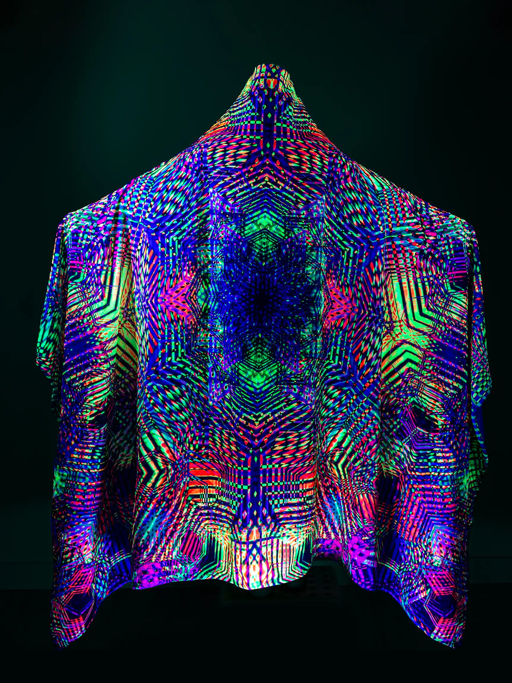 UV‑Reactive Hooded Blanket Poncho by Yantrart Designs glowing under black light, featuring sacred geometry patterns in vibrant colors on ultra‑soft flannel fleece with built‑in hood, buttons, and pockets, perfect for festivals, meditation, and visionary fashion.